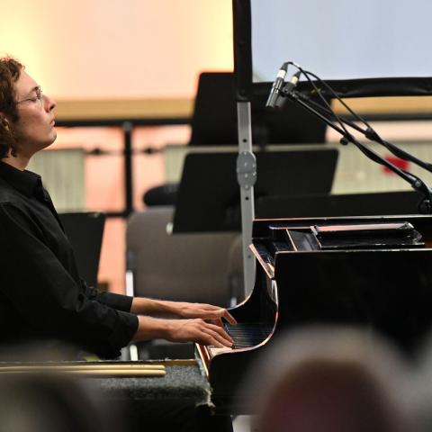 This is a profile shot of Ben while he plays the piano.