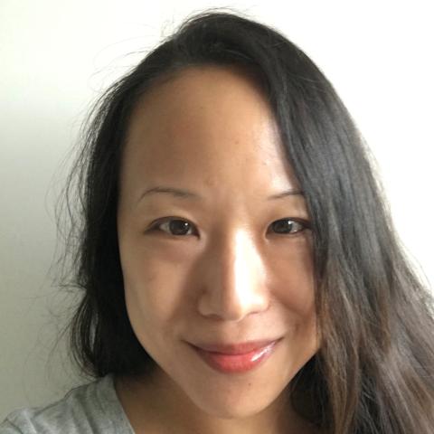 A selfie of Christine in front of a white background.