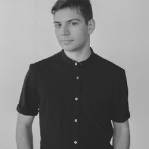 Black and white photo of Juan Salvador. He is wearing a dark shirt. 