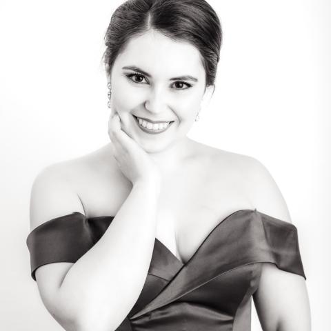 Black and white headshot of person in an off the shoulder dress