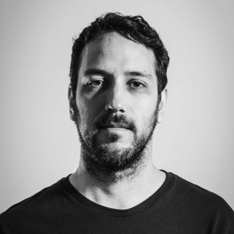 Man with beard looking into the camera