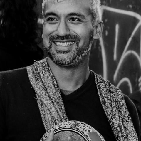 Man holding drum looking away into the crowd